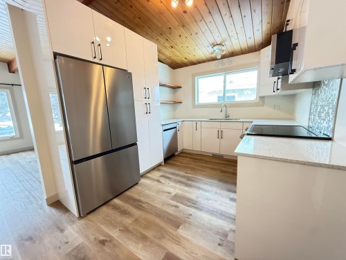Kitchen featuring wood ceiling, open shelves, stainless steel appliances, white cabinets, and light wood-style floors - 9034 60 Street, Edmonton, AB - Indoor Photo Showing Kitchen With Stainless Steel Kitchen