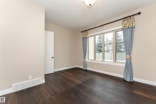 Empty room with dark wood-type flooring and a textured ceiling - 3520 Watson Point(E), Edmonton, AB - Indoor Photo Showing Other Room
