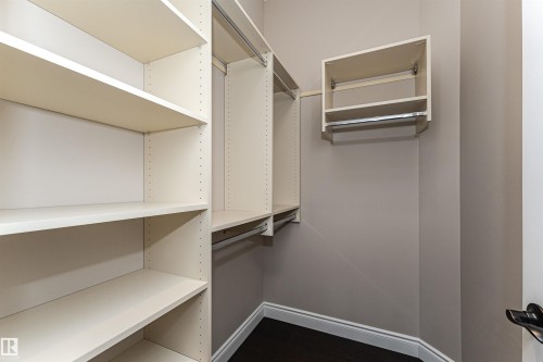 Walk in closet with dark wood-type flooring - 3520 Watson Point(E), Edmonton, AB - Indoor With Storage