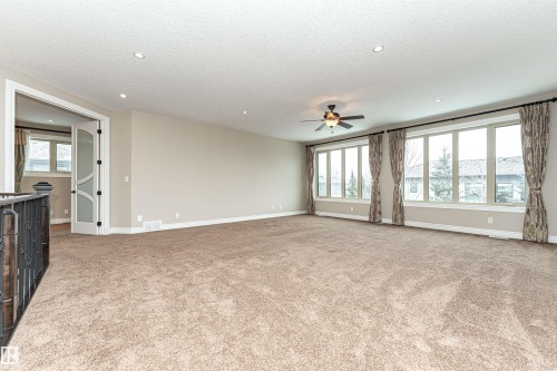 Unfurnished living room featuring light colored carpet, a ceiling fan, recessed lighting, and a textured ceiling - 3520 Watson Point(E), Edmonton, AB - Indoor Photo Showing Other Room
