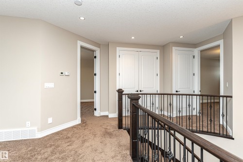 Hallway featuring light colored carpet, recessed lighting, an upstairs landing, and a textured ceiling - 3520 Watson Point(E), Edmonton, AB - Indoor Photo Showing Other Room