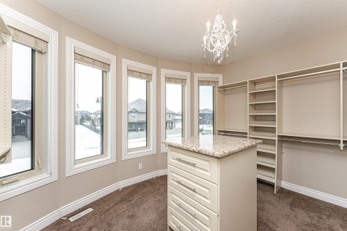 Walk in closet featuring dark colored carpet and hanging lights - 3520 Watson Point(E), Edmonton, AB - Indoor Photo Showing Other Room