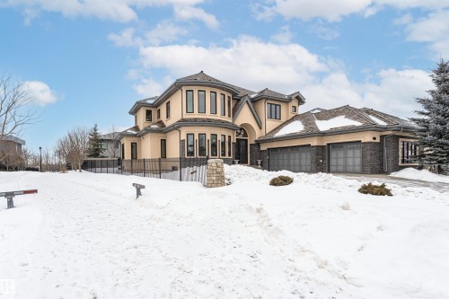 View of front facade featuring stucco siding, an attached garage, and stone siding - 3520 Watson Point(E), Edmonton, AB - Outdoor With Facade