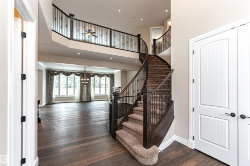 Foyer entrance with dark wood finished floors, a high ceiling, and hanging lights - 3520 Watson Point(E), Edmonton, AB - Indoor Photo Showing Other Room