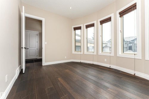 Empty room featuring dark wood finished floors and baseboards - 3520 Watson Point(E), Edmonton, AB - Indoor Photo Showing Other Room