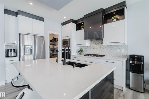 Kitchen with stainless steel appliances, white cabinetry, modern cabinets, and recessed lighting - 16217 32 Avenue, Edmonton, AB - Indoor Photo Showing Kitchen With Double Sink With Upgraded Kitchen
