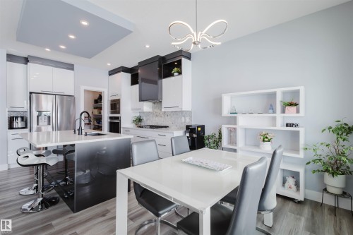 Dining area with hanging lights and light wood finished floors - 16217 32 Avenue, Edmonton, AB - Indoor