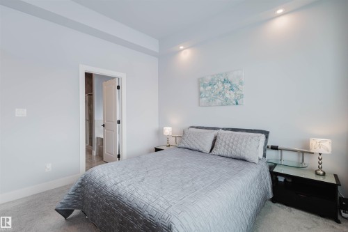 Bedroom featuring light carpet, recessed lighting, and connected bathroom - 16217 32 Avenue, Edmonton, AB - Indoor Photo Showing Bedroom