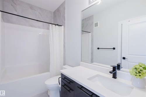Full bath with vanity and shower / bath combo with shower curtain - 16217 32 Avenue, Edmonton, AB - Indoor Photo Showing Bathroom