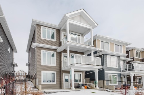 Rear view of house with a balcony, a gate, and a patio area - 16217 32 Avenue, Edmonton, AB - Outdoor With Balcony With Facade