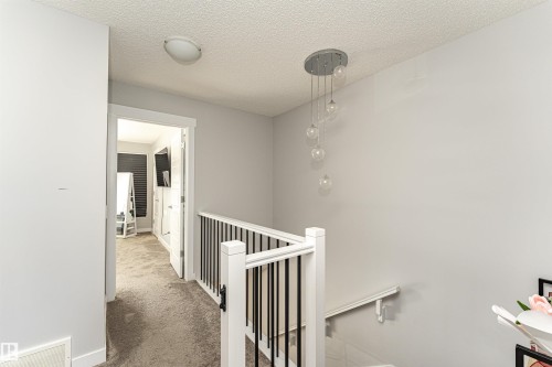 Corridor with an upstairs landing, a textured ceiling, and carpet - 16616 31 Avenue, Edmonton, AB - Indoor Photo Showing Other Room