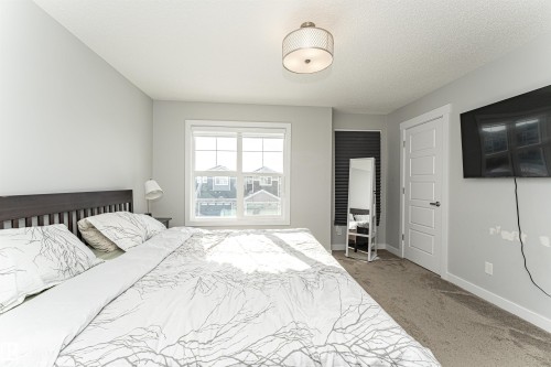 Bedroom with light colored carpet and a textured ceiling - 16616 31 Avenue, Edmonton, AB - Indoor Photo Showing Bedroom
