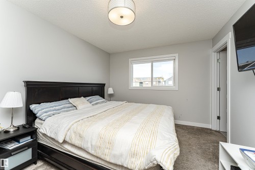 Bedroom featuring carpet floors and a textured ceiling - 16616 31 Avenue, Edmonton, AB - Indoor Photo Showing Bedroom
