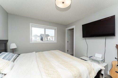 Bedroom with a textured ceiling - 16616 31 Avenue, Edmonton, AB - Indoor Photo Showing Bedroom