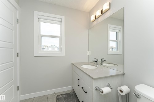 Bathroom with vanity, a textured ceiling, and light tile patterned flooring - 16616 31 Avenue, Edmonton, AB - Indoor Photo Showing Bathroom