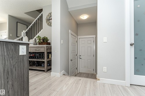 Foyer featuring light wood-style flooring and a textured ceiling - 16616 31 Avenue, Edmonton, AB - Indoor Photo Showing Other Room