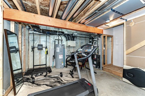 Workout area with concrete floors and electric water heater - 16616 31 Avenue, Edmonton, AB - Indoor Photo Showing Basement