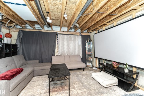 Cinema with unfinished concrete floors - 16616 31 Avenue, Edmonton, AB - Indoor Photo Showing Basement
