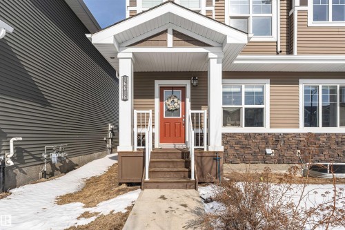 Snow covered property entrance featuring stone siding - 16616 31 Avenue, Edmonton, AB - Outdoor With Facade