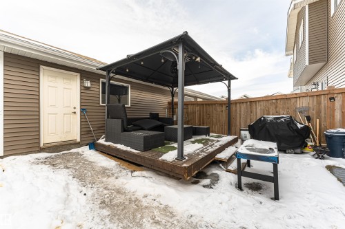 Snow covered patio featuring a grill, a deck, a fenced backyard, and an outdoor living space - 16616 31 Avenue, Edmonton, AB - Outdoor With Deck Patio Veranda With Exterior