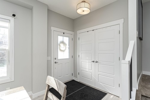 Foyer entrance with baseboards and light wood finished floors - 16616 31 Avenue, Edmonton, AB - Indoor Photo Showing Other Room