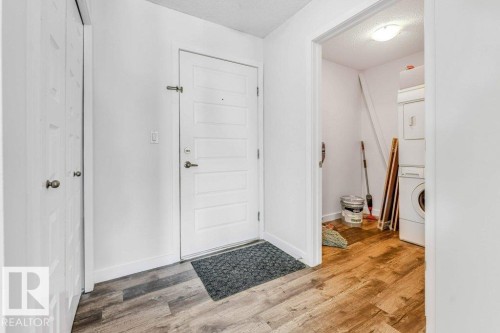 Foyer featuring a textured ceiling and light wood-style floors - 101 400 Silver Berry Road, Edmonton, AB - Indoor Photo Showing Other Room