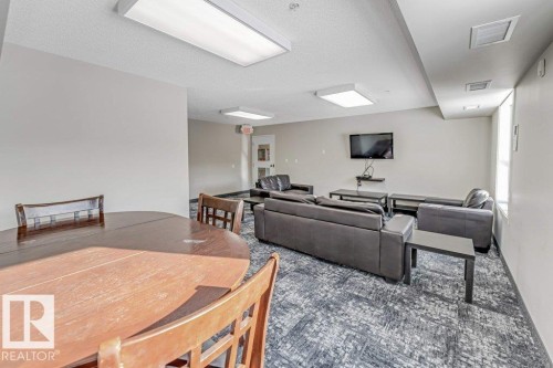 Living room with a textured ceiling - 101 400 Silver Berry Road, Edmonton, AB - Indoor