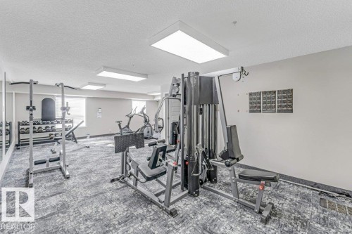 Workout area featuring a textured ceiling - 101 400 Silver Berry Road, Edmonton, AB - Indoor Photo Showing Gym Room