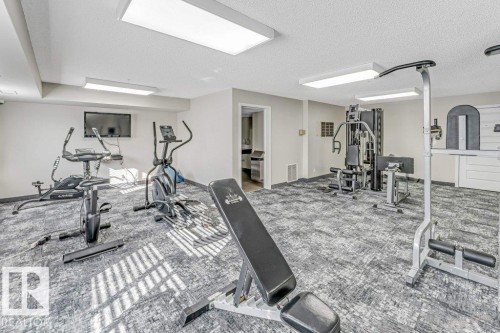 Gym with a textured ceiling - 101 400 Silver Berry Road, Edmonton, AB - Indoor Photo Showing Gym Room