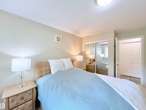 Bedroom with a textured ceiling and a closet - 110 10511 42 Avenue, Edmonton, AB - Indoor Photo Showing Bedroom