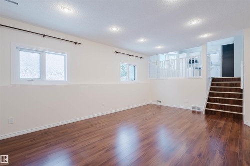 Unfurnished room with dark wood finished floors and a textured ceiling - 243 Rhatigan Road E, Edmonton, AB - Indoor Photo Showing Other Room