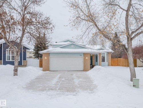 View of front of property featuring brick siding and a garage - 243 Rhatigan Road E, Edmonton, AB - Outdoor With Facade