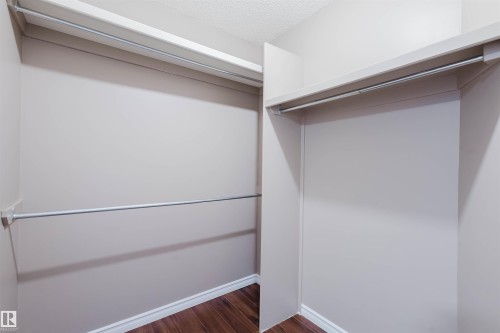 Walk in closet featuring dark wood-style floors - 243 Rhatigan Road E, Edmonton, AB - Indoor Photo Showing Other Room