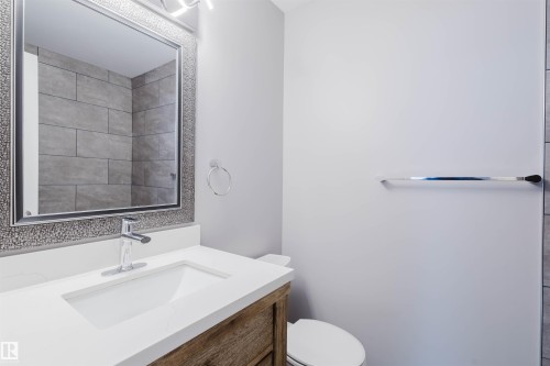 Half bath featuring vanity and toilet - 243 Rhatigan Road E, Edmonton, AB - Indoor Photo Showing Bathroom