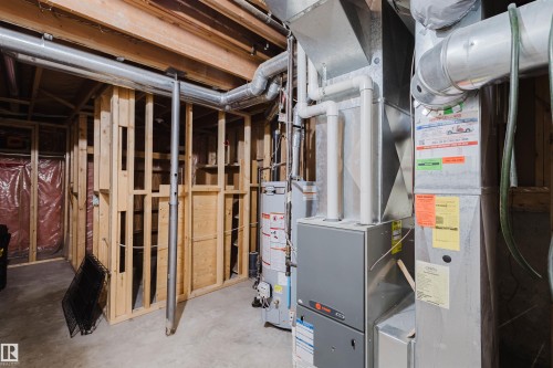 Utility room featuring water heater and heating unit - 243 Rhatigan Road E, Edmonton, AB - Indoor Photo Showing Basement