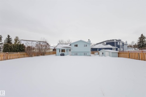Snowy yard featuring a fenced backyard and an outbuilding - 243 Rhatigan Road E, Edmonton, AB - Outdoor