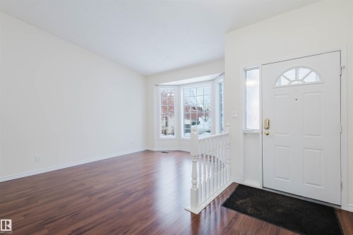 Foyer with plenty of natural light and dark wood-style flooring - 243 Rhatigan Road E, Edmonton, AB - Indoor Photo Showing Other Room