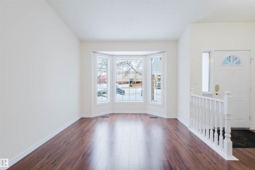 Entryway with baseboards and dark wood-style floors - 243 Rhatigan Road E, Edmonton, AB - Indoor Photo Showing Other Room