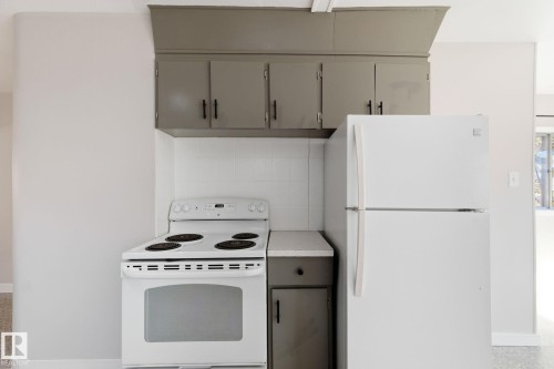 Kitchen featuring white appliances, gray cabinets, and light countertops - 12225 134 Street, Edmonton, AB - Indoor Photo Showing Kitchen