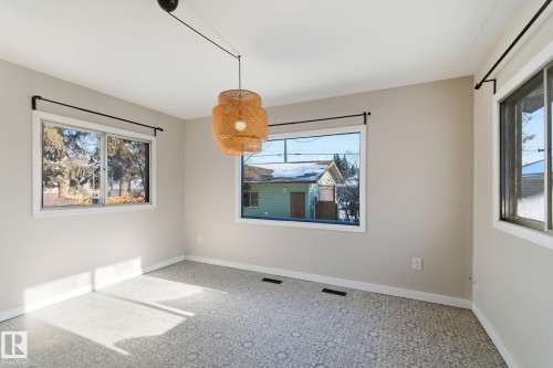 Unfurnished dining area featuring baseboards and light carpet - 12225 134 Street, Edmonton, AB - Indoor Photo Showing Other Room