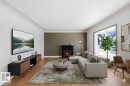 Living room with light wood-type flooring and baseboards - 12225 134 Street, Edmonton, AB  - Indoor Photo Showing Living Room With Fireplace 