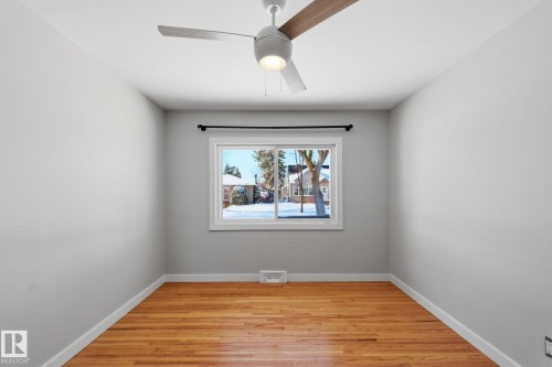 Empty room featuring light wood-style flooring and a ceiling fan - 12225 134 Street, Edmonton, AB - Indoor Photo Showing Other Room