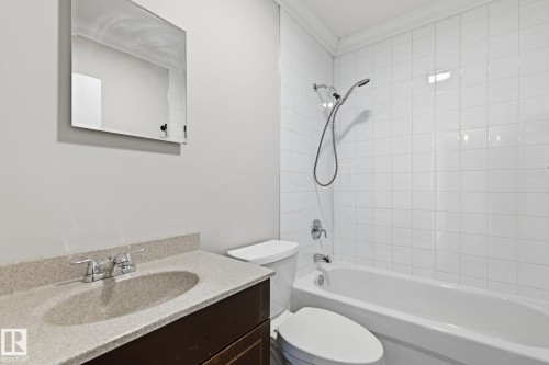 Bathroom with vanity, bathtub / shower combination, and ornamental molding - 12225 134 Street, Edmonton, AB - Indoor Photo Showing Bathroom