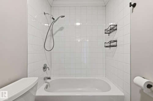 Bathroom with washtub / shower combination and ornamental molding - 12225 134 Street, Edmonton, AB - Indoor Photo Showing Bathroom