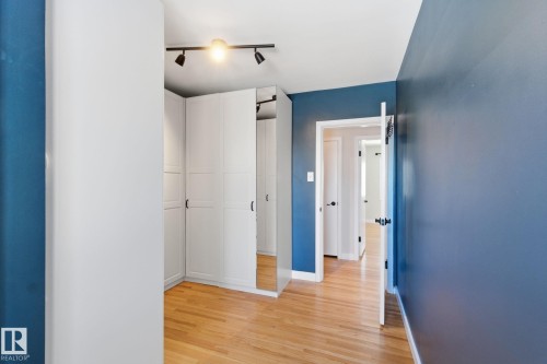 Unfurnished bedroom with track lighting, light wood finished floors, and a closet - 12225 134 Street, Edmonton, AB - Indoor Photo Showing Other Room