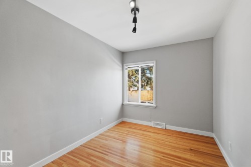 Spare room with light wood-style flooring and baseboards - 12225 134 Street, Edmonton, AB - Indoor Photo Showing Other Room