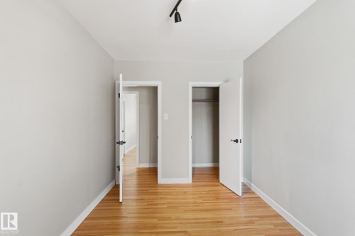 Unfurnished bedroom with light wood-style flooring and a closet - 12225 134 Street, Edmonton, AB - Indoor Photo Showing Other Room