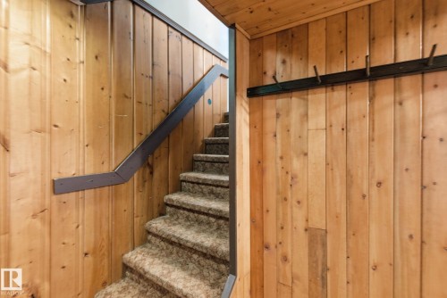 Staircase featuring wood walls - 12225 134 Street, Edmonton, AB - Indoor Photo Showing Other Room
