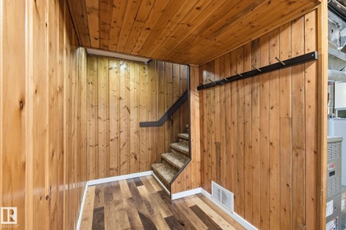 Stairs featuring wood finished floors, wood walls, and wooden ceiling - 12225 134 Street, Edmonton, AB - Indoor Photo Showing Other Room