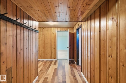 Hallway featuring light wood-style floors, wooden walls, and wooden ceiling - 12225 134 Street, Edmonton, AB - Indoor Photo Showing Other Room